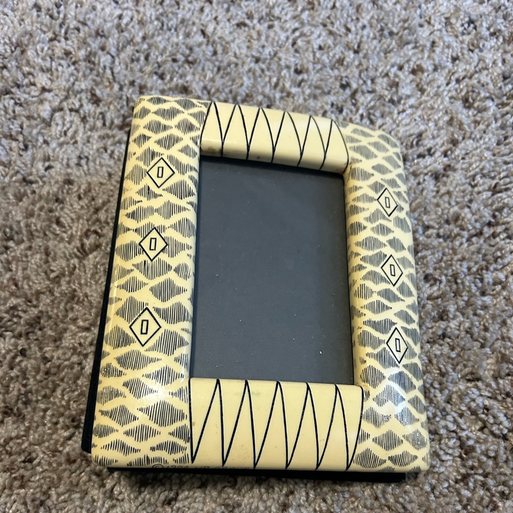 Burned African photo album. Cover frame is plastic.